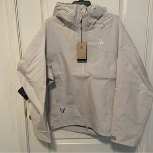 Nike ACG Light Gray Raincoat size small. 
Has tiny pinhole from sales tag.